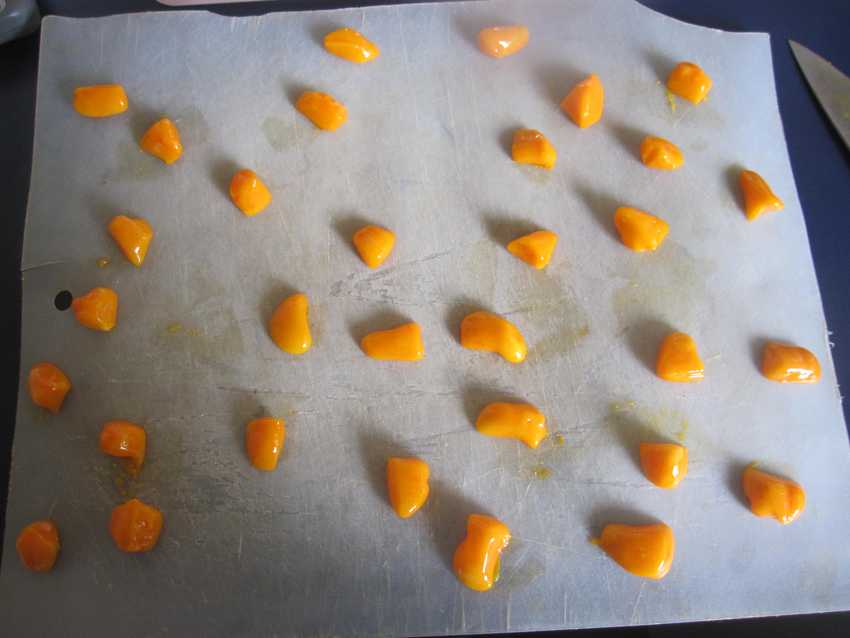 chopping board with 32 very irregularly shaped pices of yellow fondant