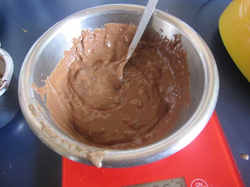 lumpy mix of hazelnut butter and chocolate in metal bowl