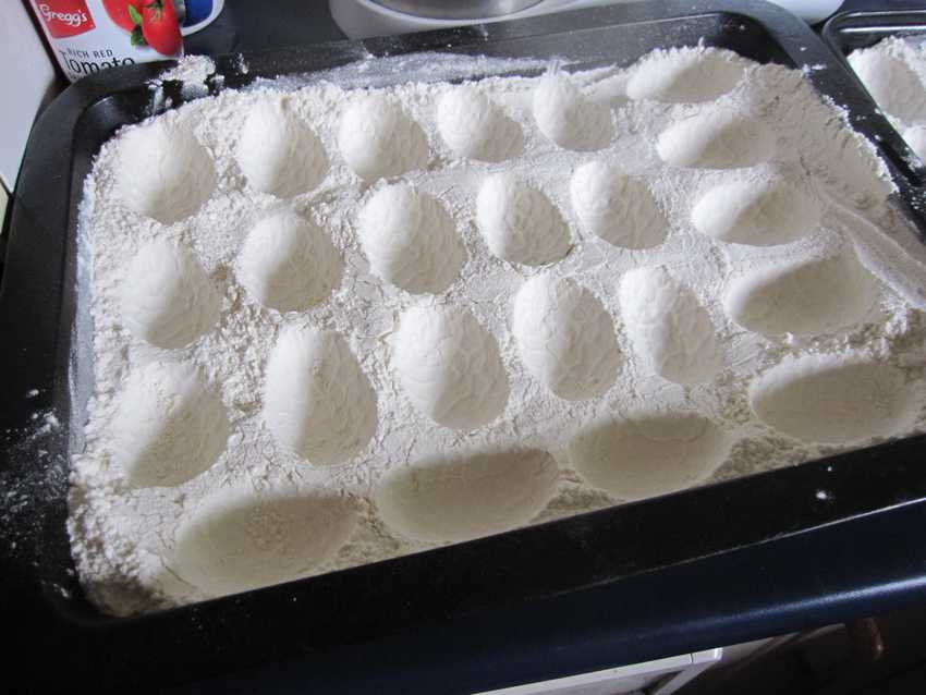 tray of flour with egg-shaped depressions