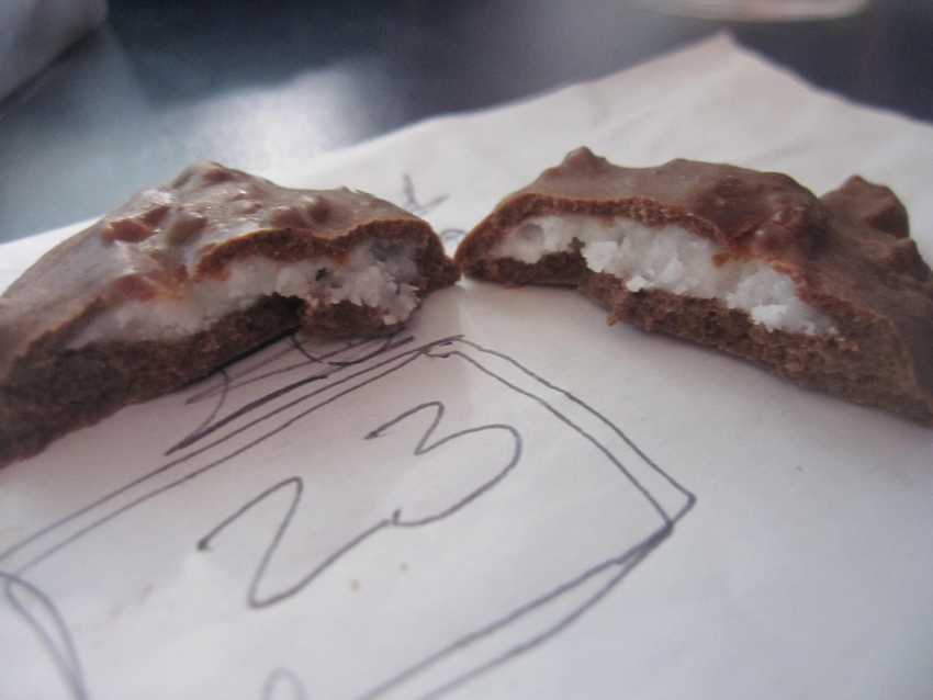 two halves of egg sliced vertically with static, dry filling on paper with sample number 23