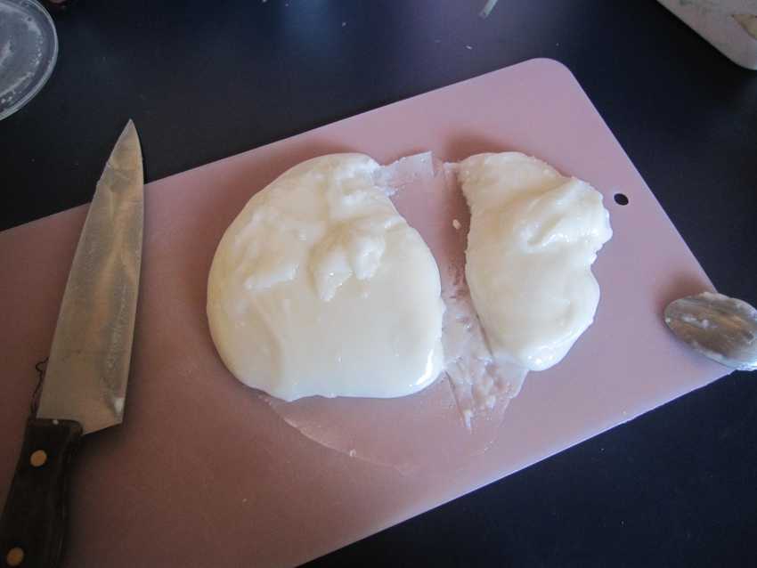 chopping board with white blob cut into 1/3 and 2/3 segments