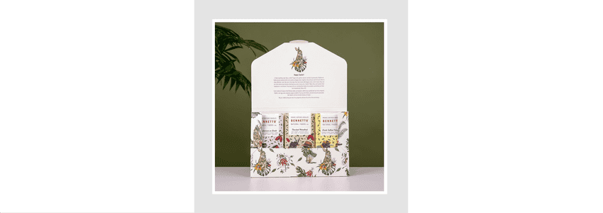 Open box of Bennetto chocolate showing 3 bars inside and images of Easter bunny rabbits and plants across the box