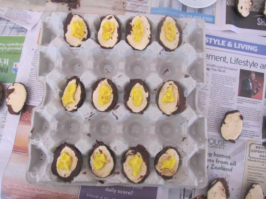 tray of half-eggs, round side down, with yolks on top